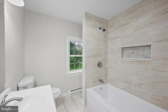 a bathroom with a toilet and shower