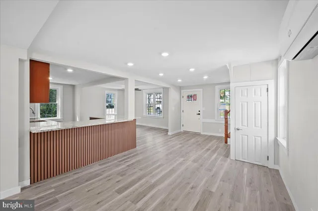 a view of a kitchen with wooden floor and windows
