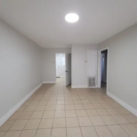 an empty room with white walls and tiles