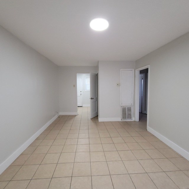 2406 Dawson Street, Unit 4 Columbus, GA 31903 - Photo 2 of 8 an empty room with white walls and tiles