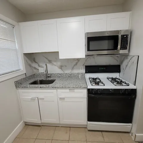 a kitchen with a stove and a microwave