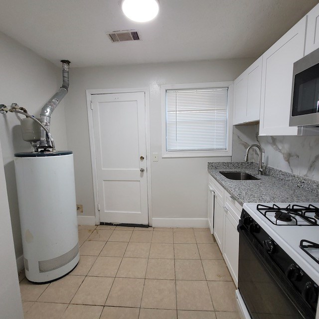 2406 Dawson Street, Unit 4 Columbus, GA 31903 - Photo 5 of 8 a kitchen with a sink a stove and refrigerator