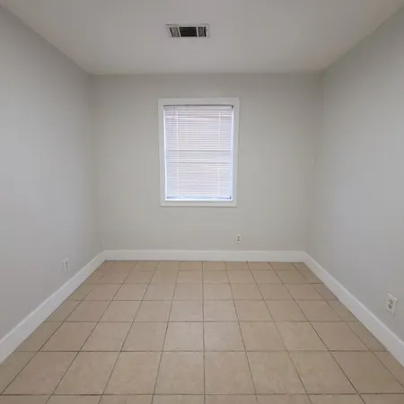 an empty room with white walls and tiles