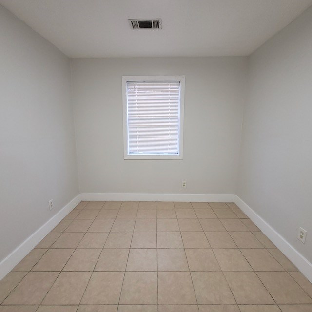 2406 Dawson Street, Unit 4 Columbus, GA 31903 - Photo 8 of 8 an empty room with white walls and tiles