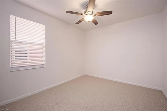a view of a room with window and hardwood floor