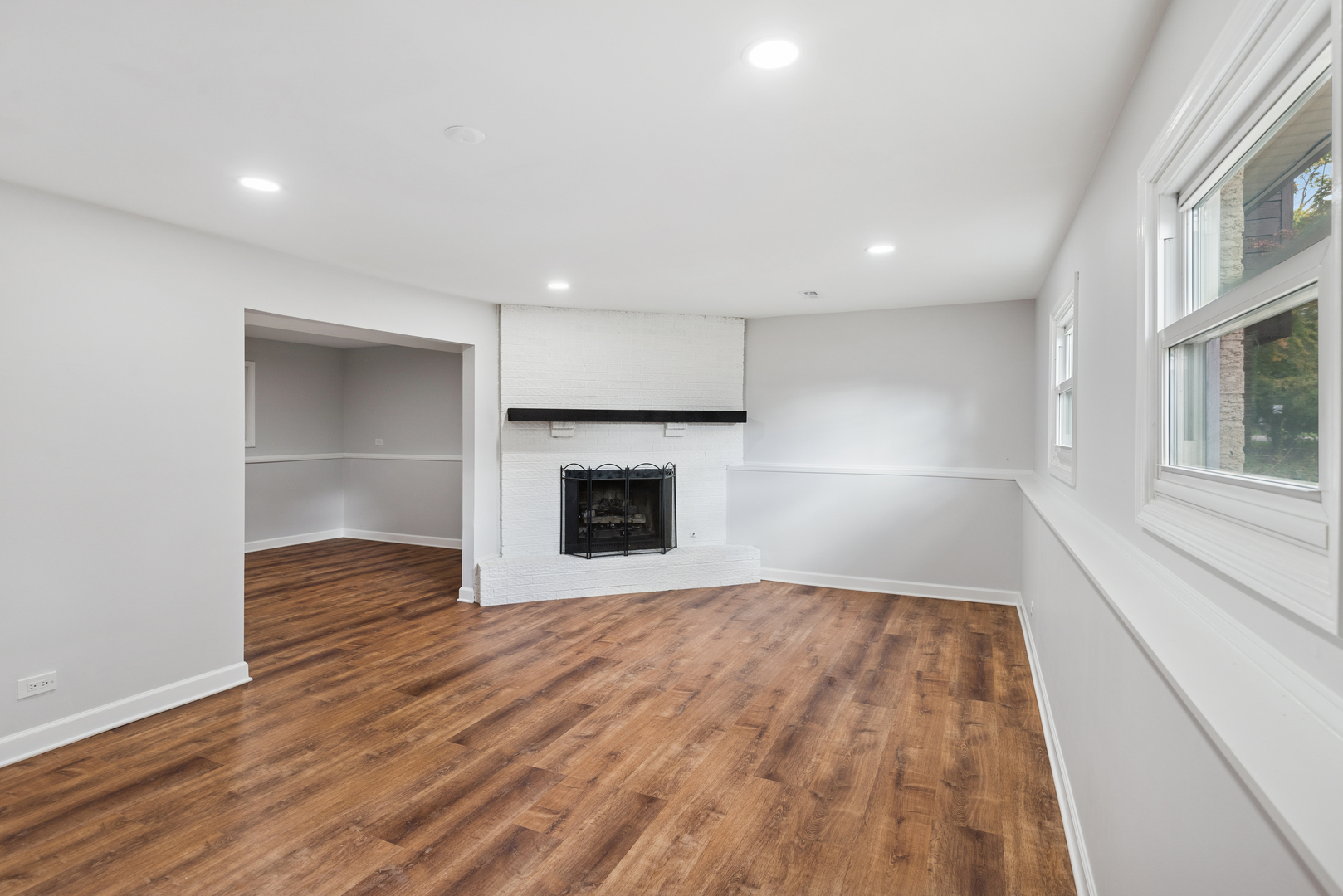 18 Greenview Road Oakwood Hills, IL 60013 - Photo 20 of 35 a view of empty room with wooden floor and fireplace