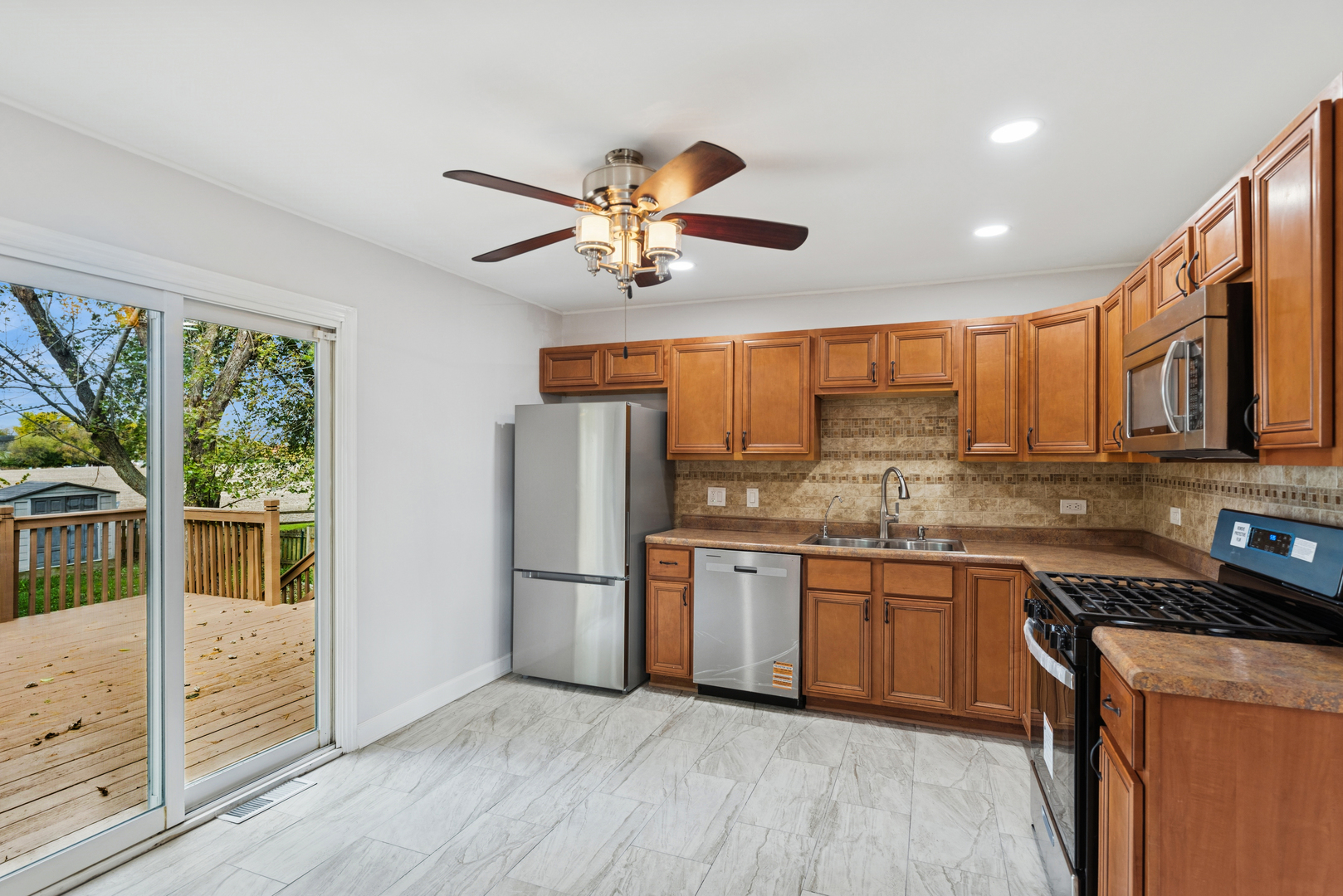 18 Greenview Road Oakwood Hills, IL 60013 - Photo 9 of 35 a kitchen with stainless steel appliances granite countertop hardwood floor sink stove and refrigerator