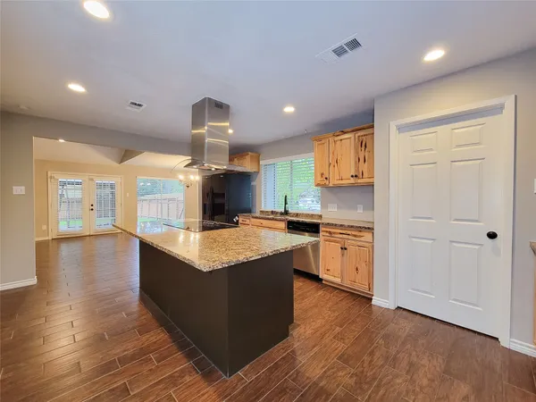 a kitchen with granite countertop a stove and a sink