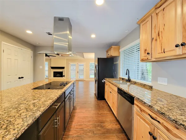 a large kitchen with granite countertop a sink and a stove