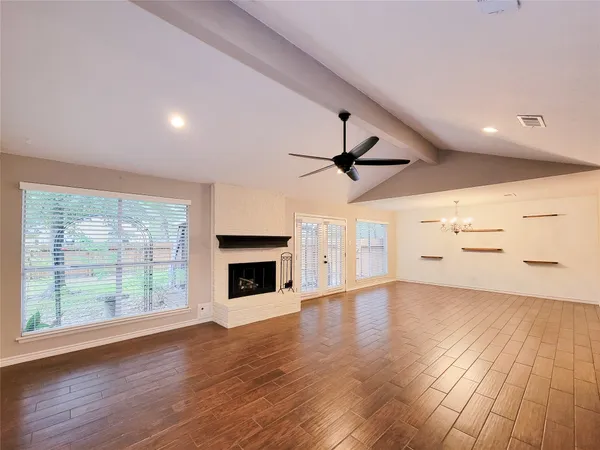 wooden floor in an empty room with a fireplace