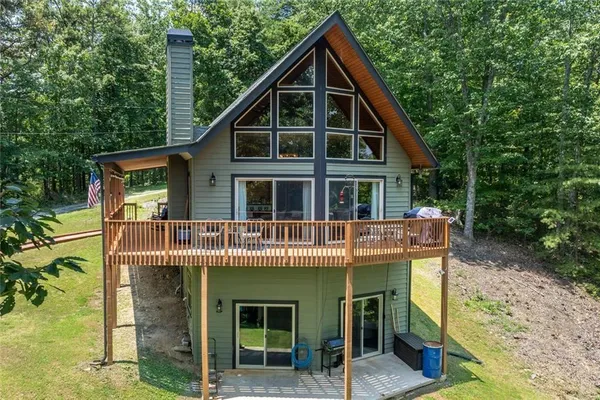 a view of a house with a yard balcony and furniture