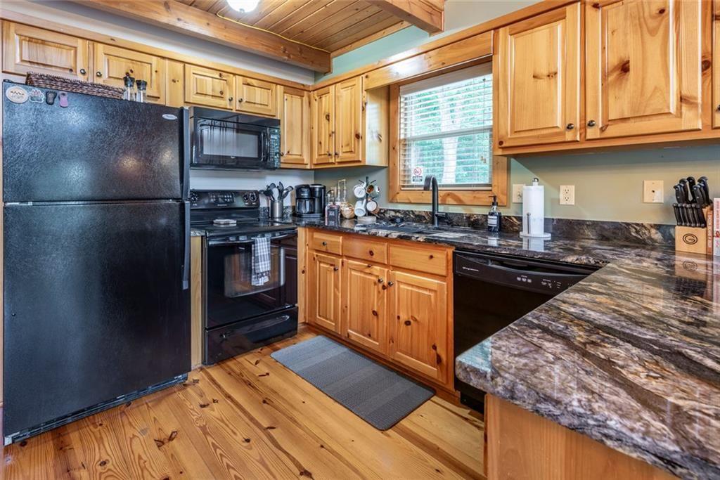 1328 Birch Lane Ranger, GA 30734 - Photo 12 of 33 a kitchen with stainless steel appliances granite countertop a stove a refrigerator and a sink