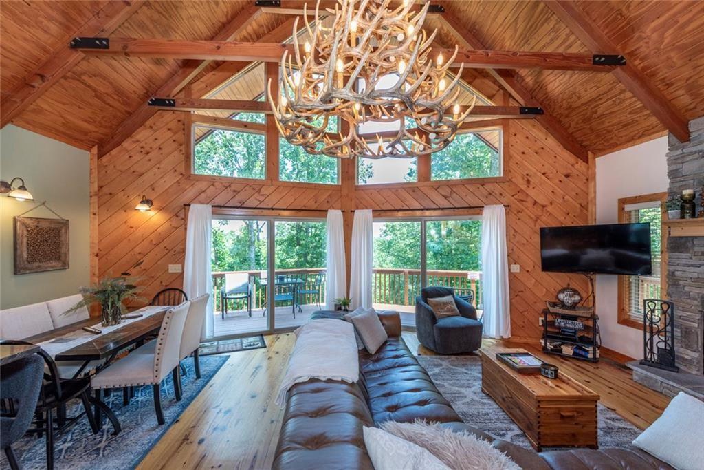 1328 Birch Lane Ranger, GA 30734 - Photo 10 of 33 a living room with furniture a flat screen tv and a floor to ceiling window