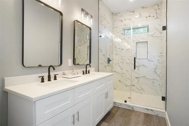 a bathroom with a shower sink and mirror