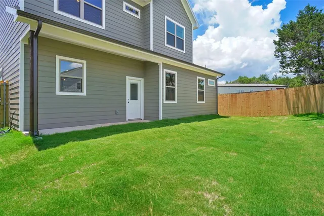 a view of house with backyard
