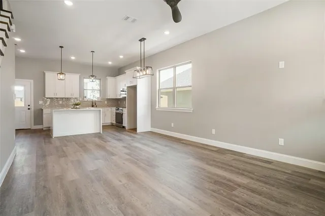 a view of a kitchen with a sink and a window