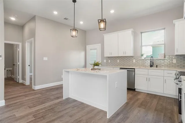 a kitchen with a sink window and cabinets