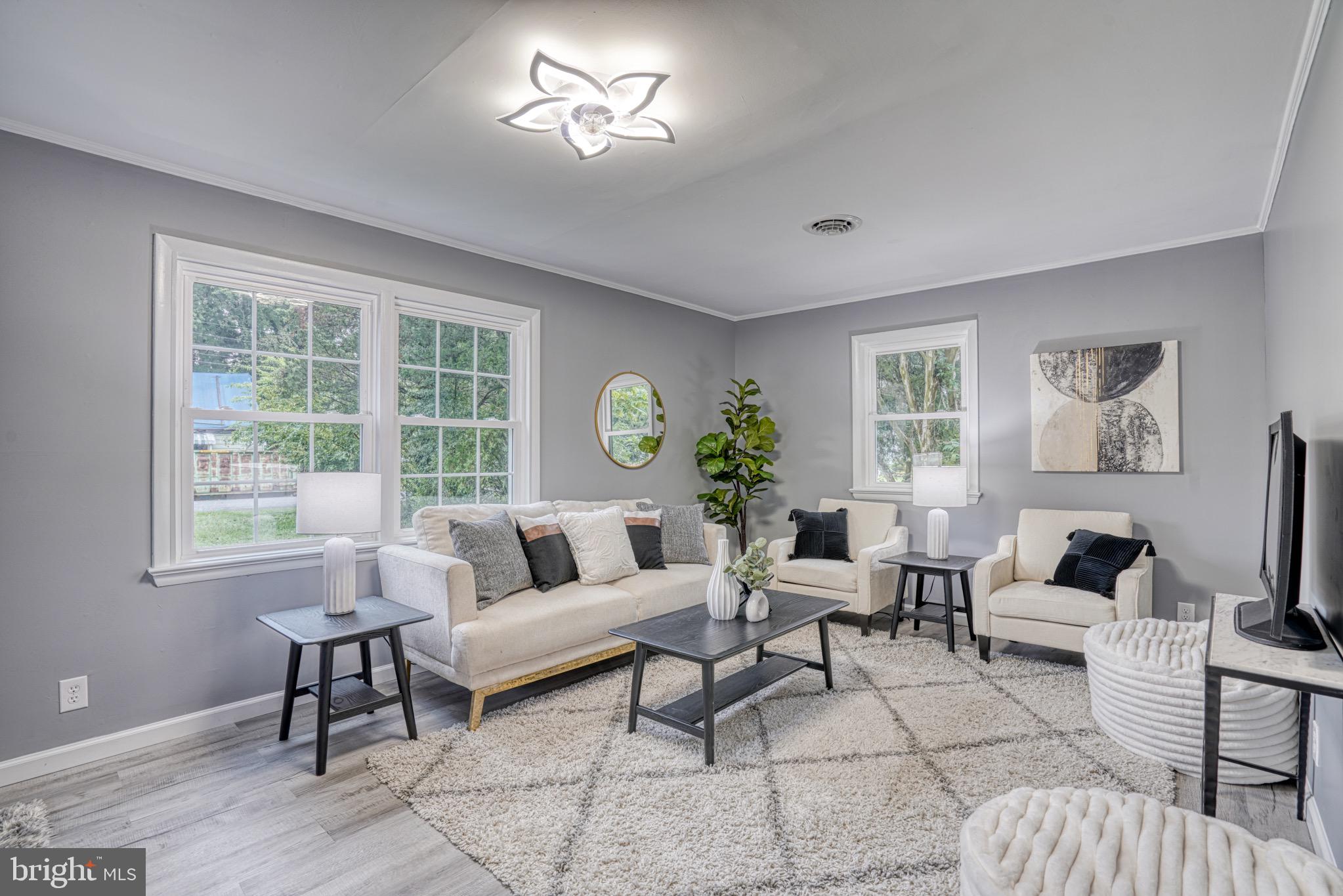 18 Oak Street Cambridge, MD 21613 - Photo 1 of 43 a living room with furniture a chandelier and a window