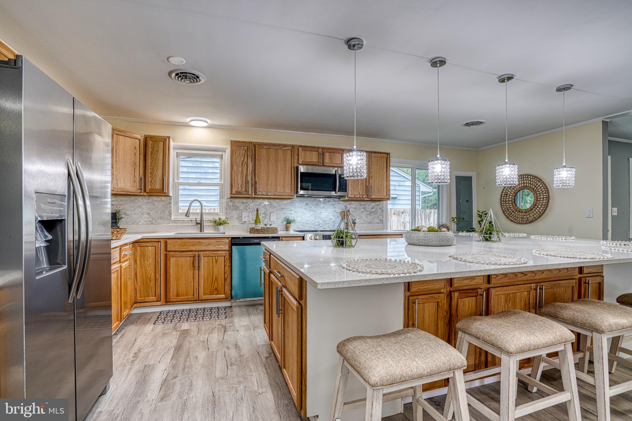 18 Oak Street Cambridge, MD 21613 - Photo 11 of 43 a kitchen with a sink stainless steel appliances and cabinets