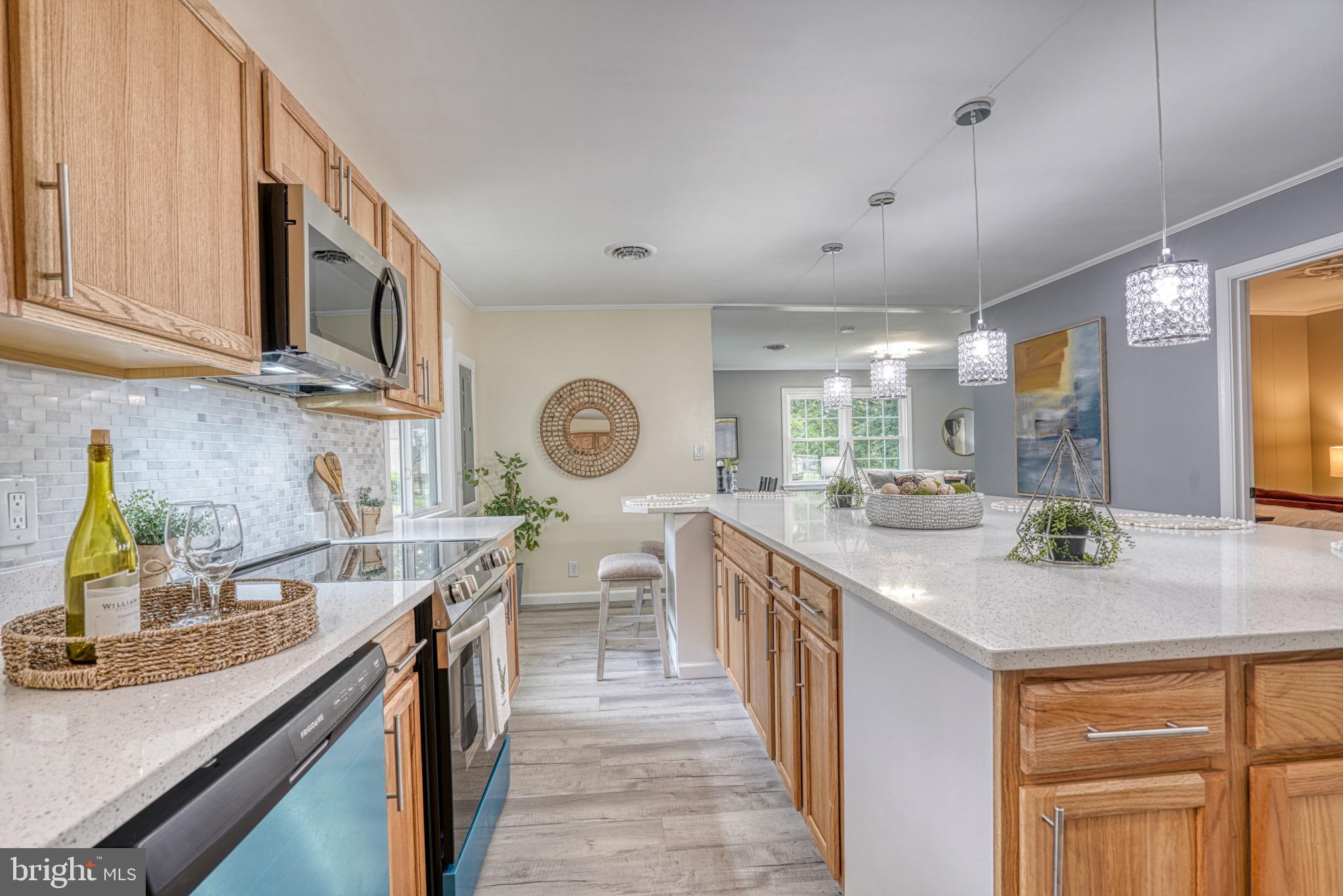 18 Oak Street Cambridge, MD 21613 - Photo 12 of 43 a kitchen with stainless steel appliances granite countertop a sink stove and cabinets