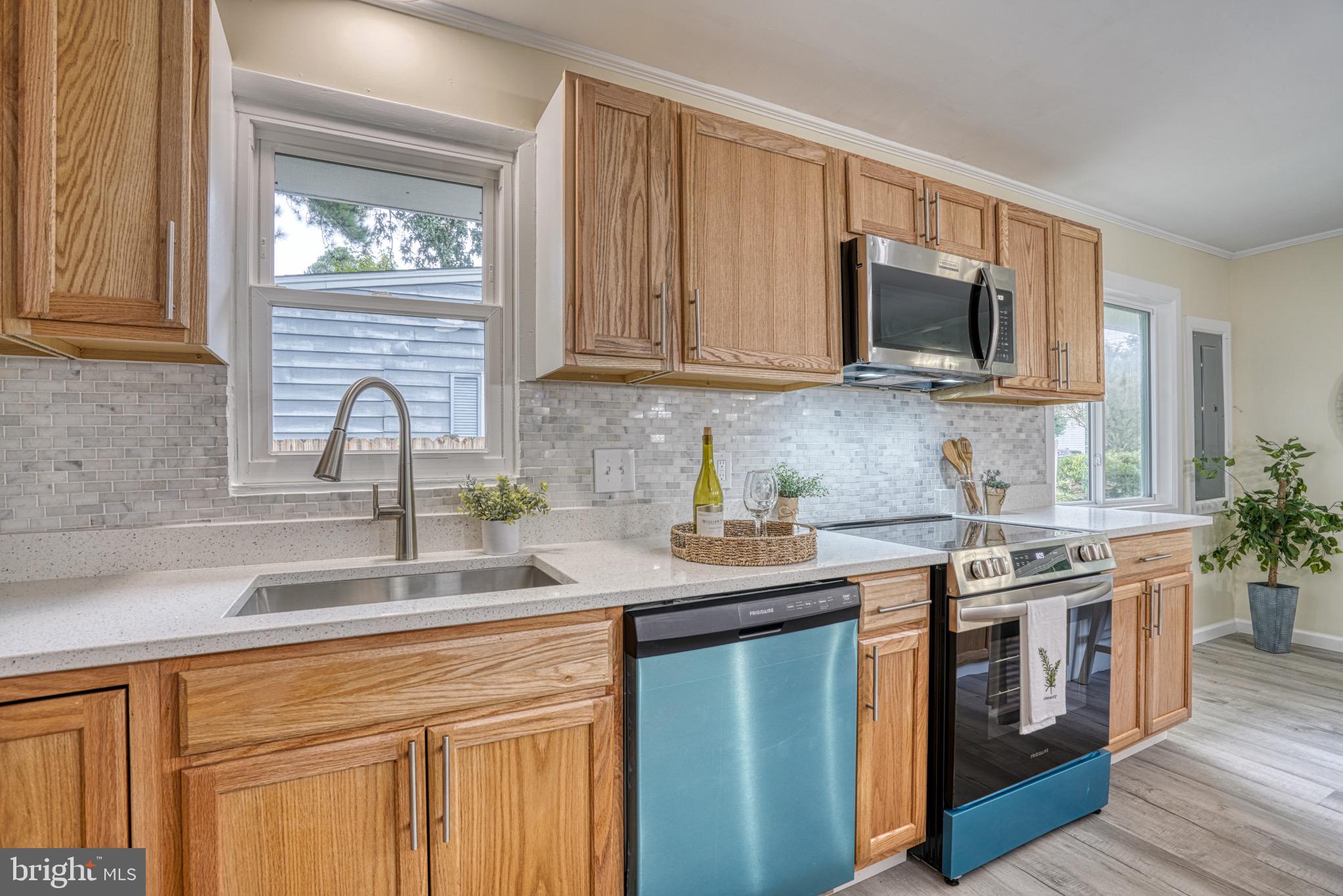 18 Oak Street Cambridge, MD 21613 - Photo 13 of 43 a kitchen with stainless steel appliances granite countertop a sink stove and microwave