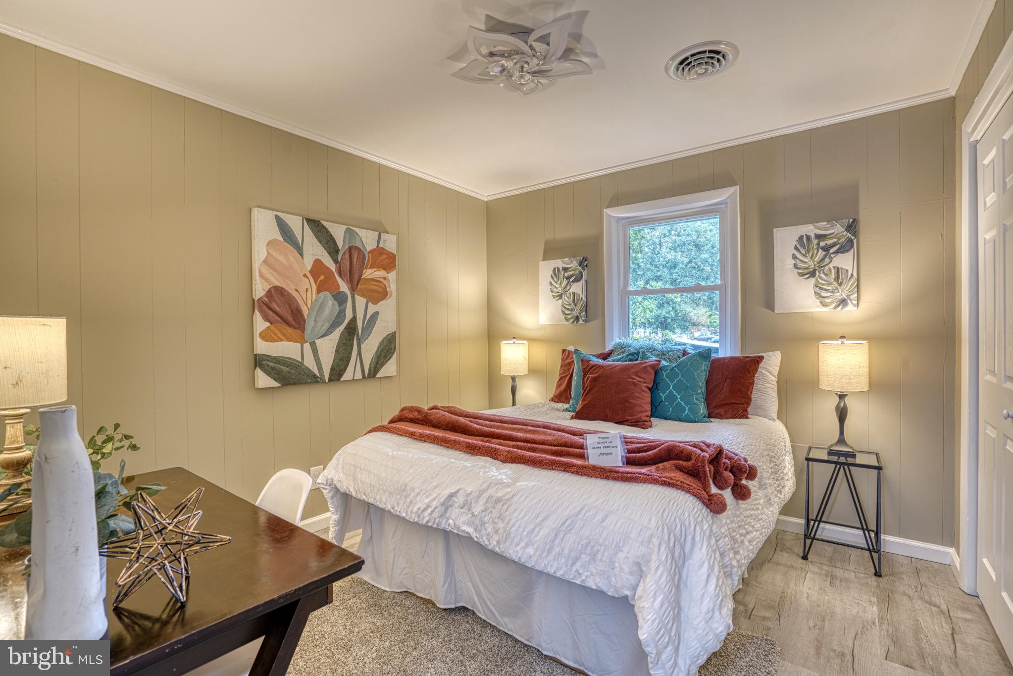 18 Oak Street Cambridge, MD 21613 - Photo 14 of 43 a bedroom with bed and wooden floor