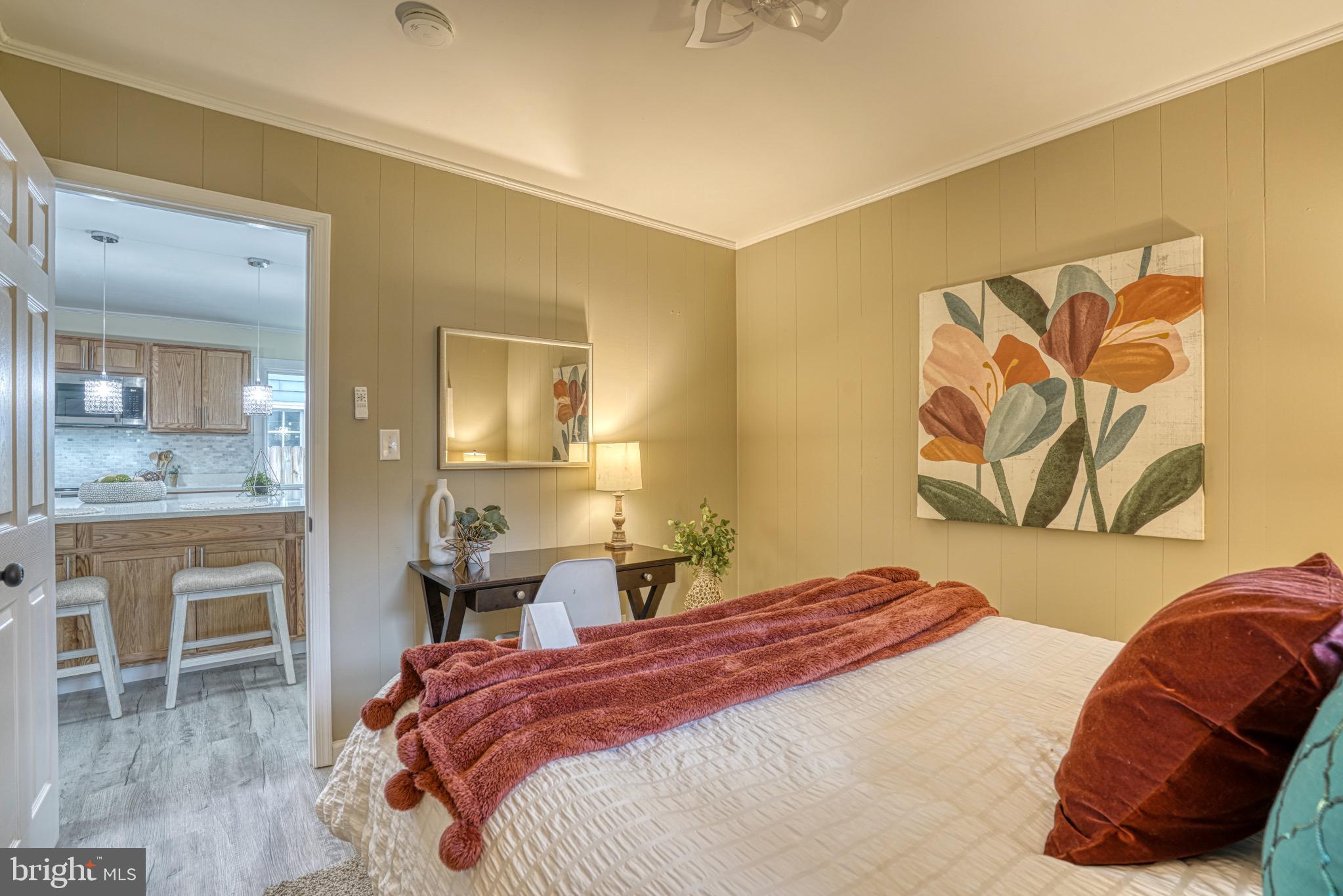 18 Oak Street Cambridge, MD 21613 - Photo 17 of 43 a bedroom with a bed and a chair