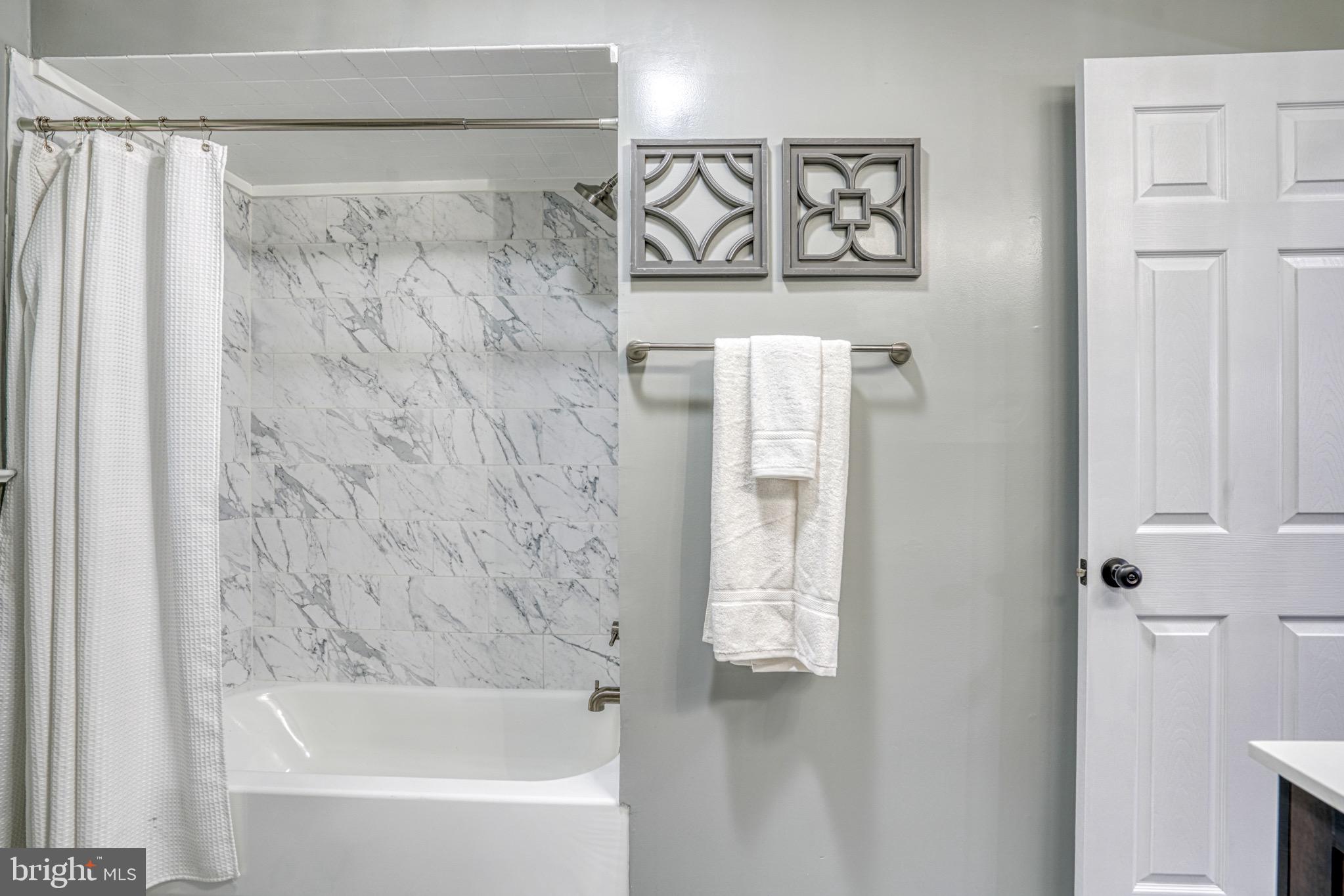 18 Oak Street Cambridge, MD 21613 - Photo 20 of 43 a bathroom with a bathtub and shower