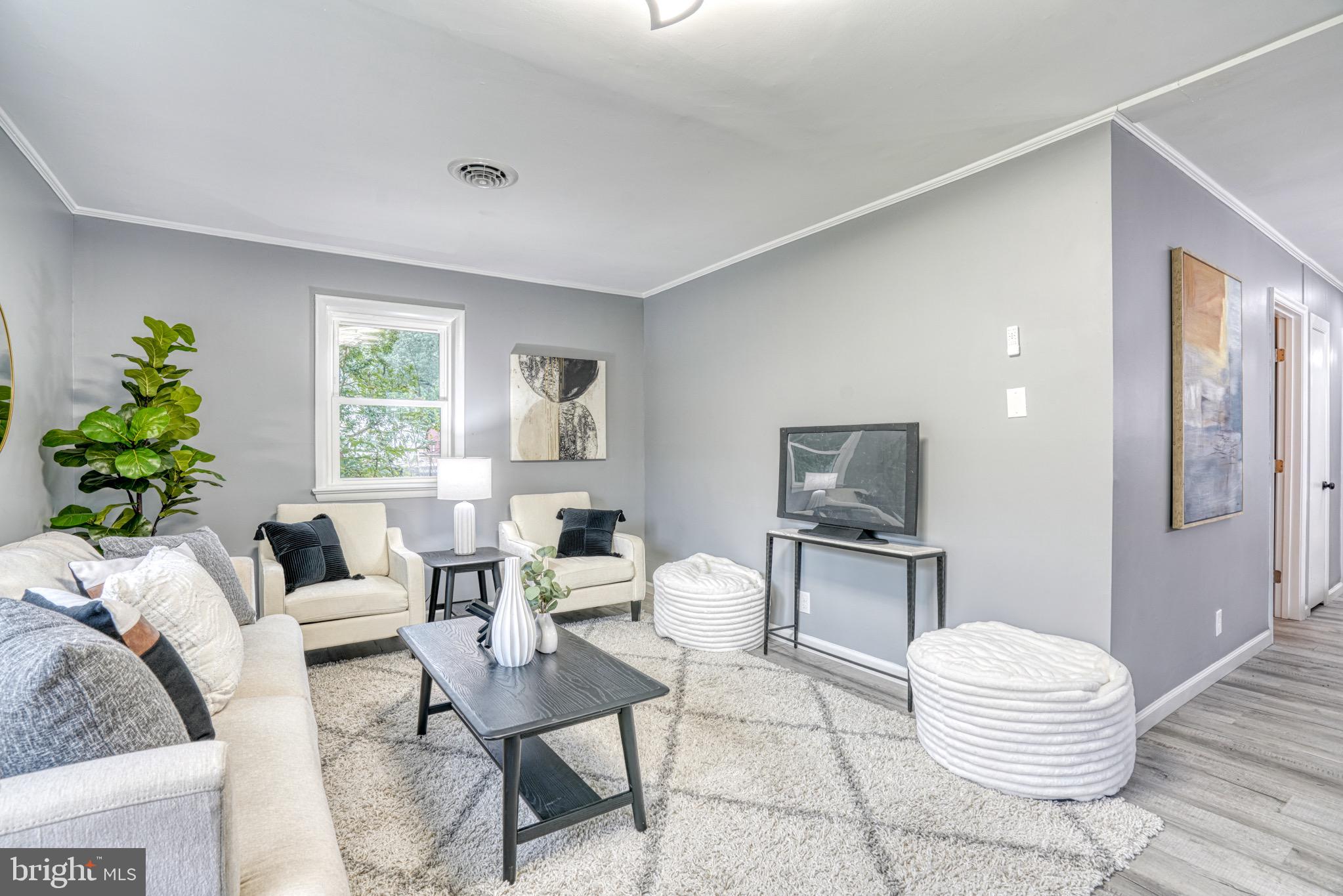 18 Oak Street Cambridge, MD 21613 - Photo 2 of 43 a living room with furniture and a wooden floor