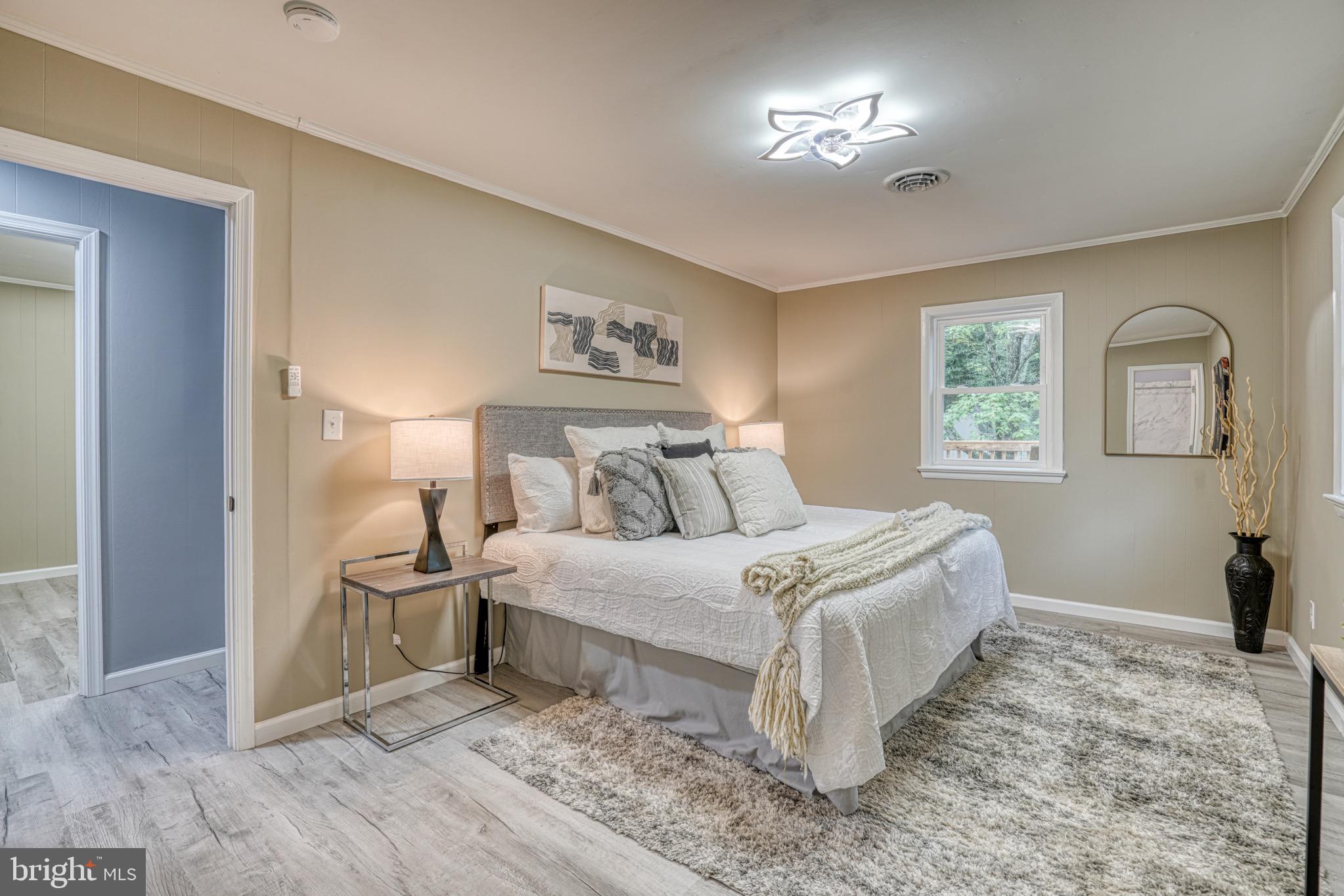 18 Oak Street Cambridge, MD 21613 - Photo 21 of 43 a bedroom with a bed and a chandelier