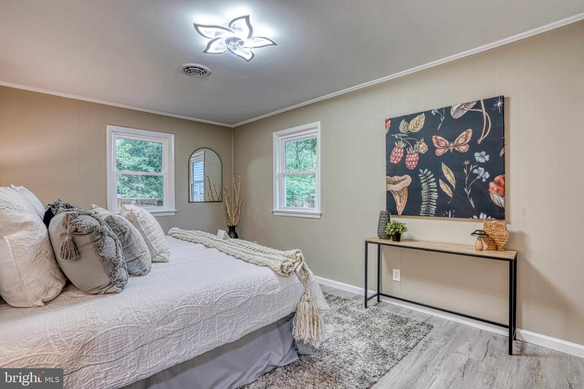 18 Oak Street Cambridge, MD 21613 - Photo 22 of 43 a bedroom with a bed and a painting on the wall