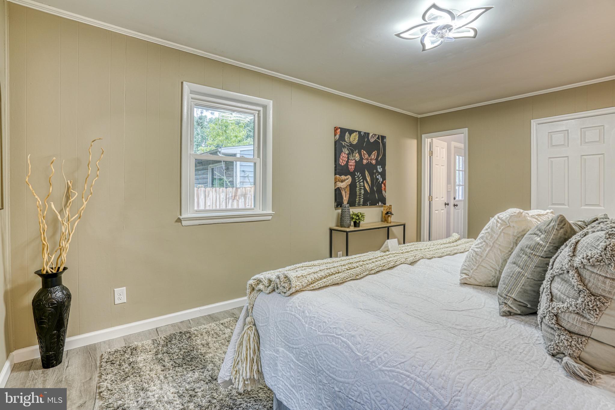 18 Oak Street Cambridge, MD 21613 - Photo 24 of 43 a bedroom with a bed and a painting on the wall
