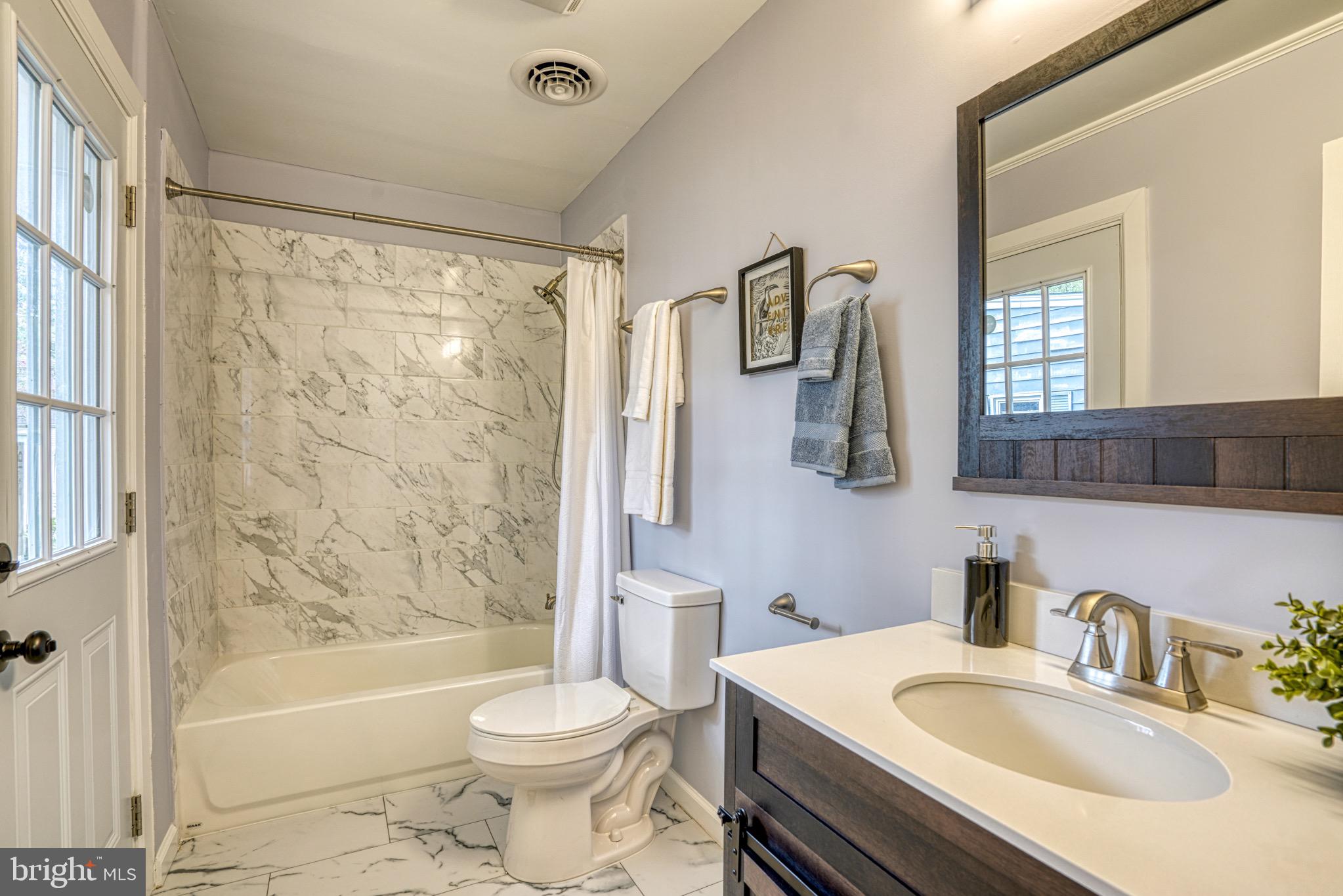 18 Oak Street Cambridge, MD 21613 - Photo 27 of 43 a bathroom with a sink toilet and shower