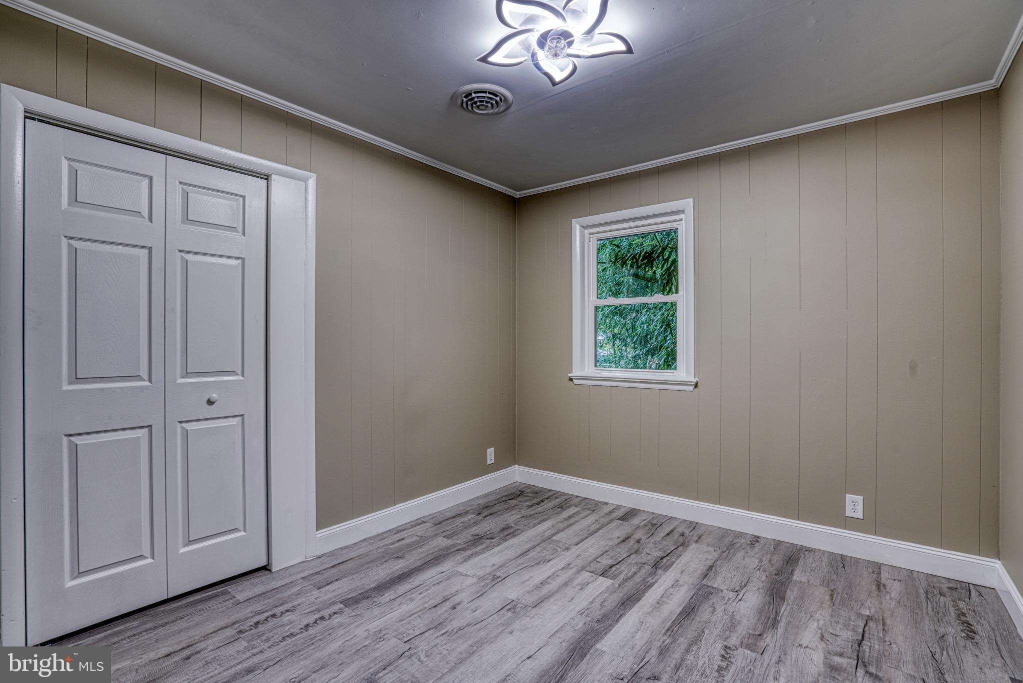 18 Oak Street Cambridge, MD 21613 - Photo 29 of 43 a view of an empty room with wooden floor and a window