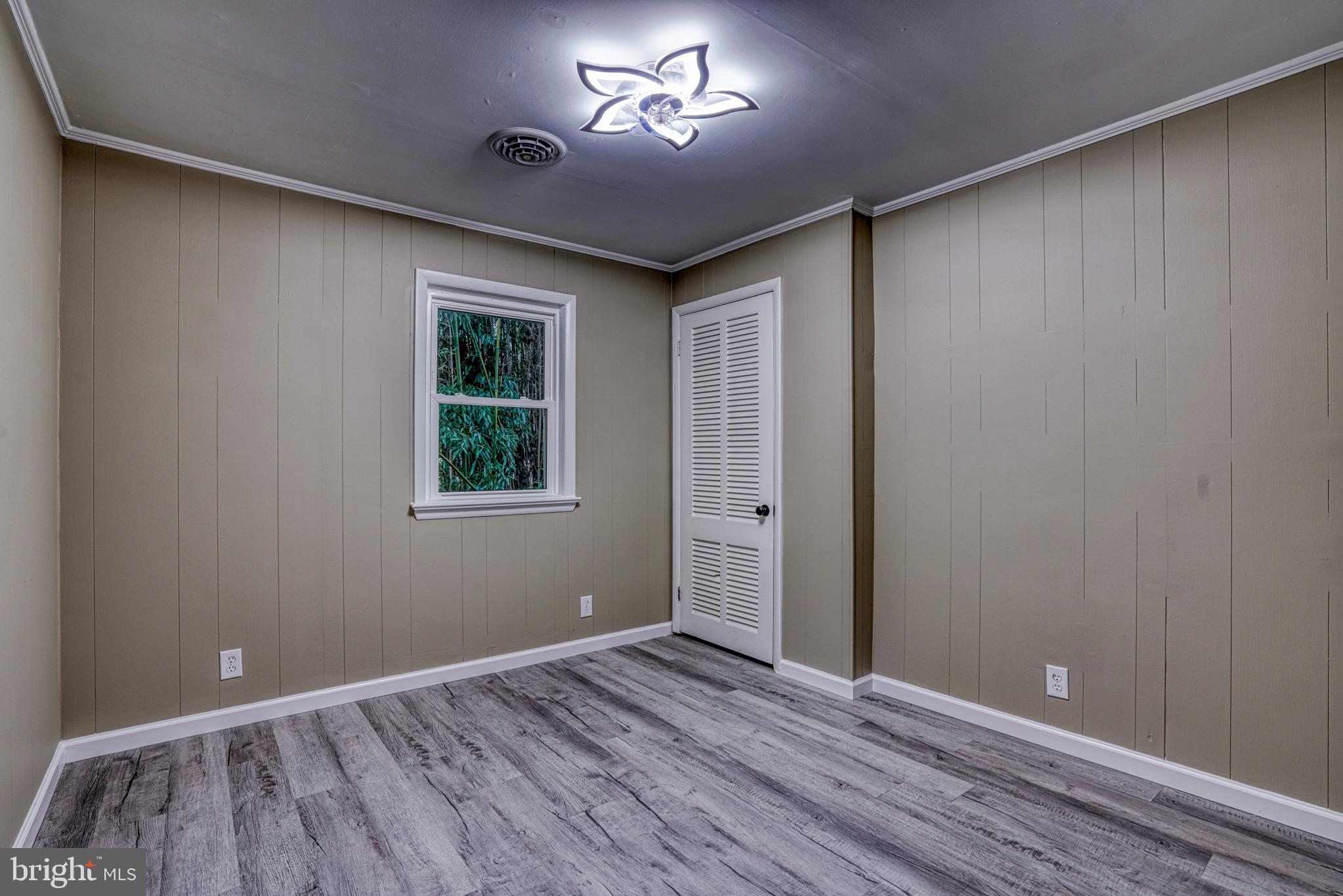 18 Oak Street Cambridge, MD 21613 - Photo 31 of 43 a view of room with window ceiling fan and hardwood floor