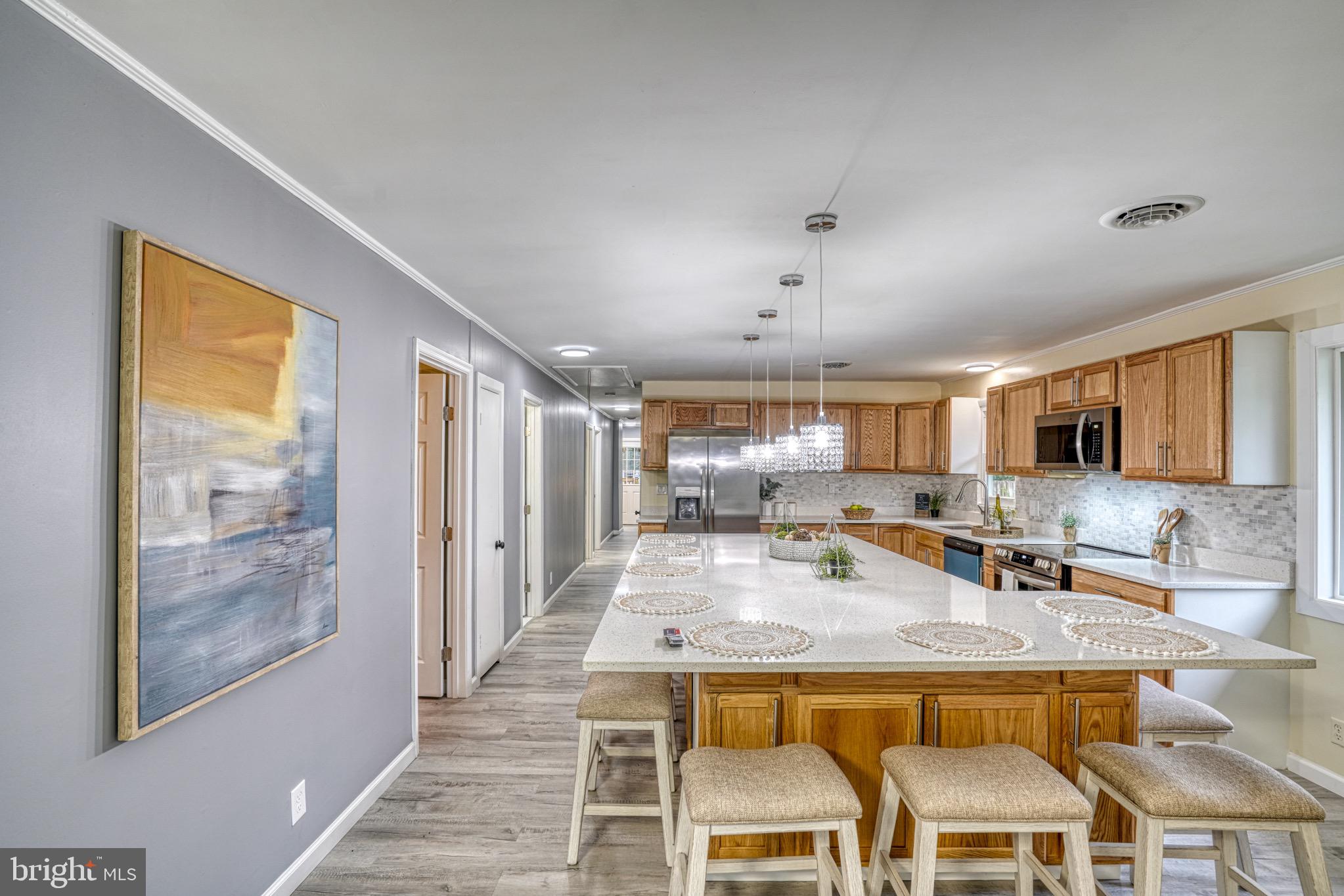 18 Oak Street Cambridge, MD 21613 - Photo 8 of 43 a view of a kitchen with kitchen island and stainless steel appliances