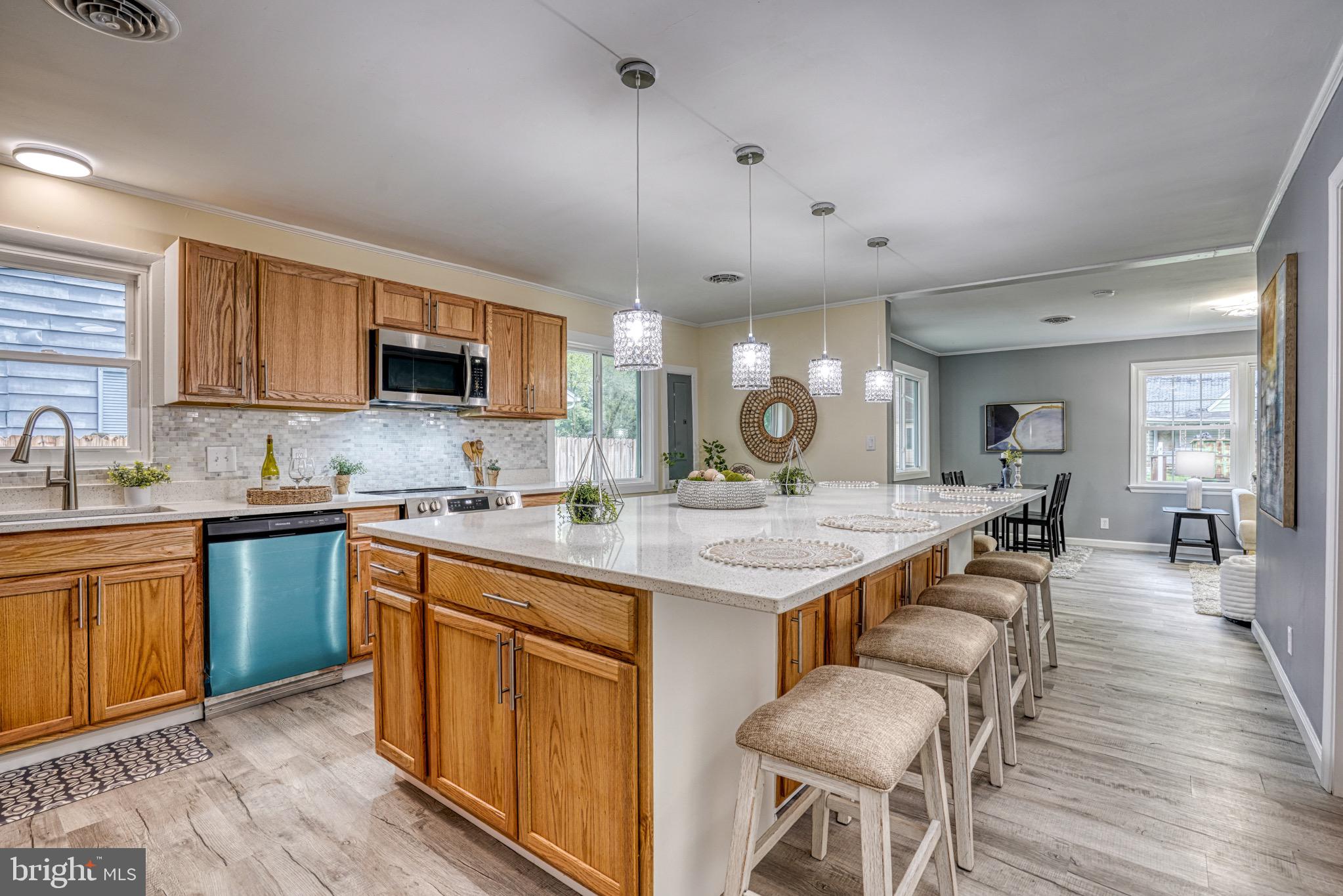 18 Oak Street Cambridge, MD 21613 - Photo 10 of 43 a kitchen with a sink stove cabinets and wooden floor
