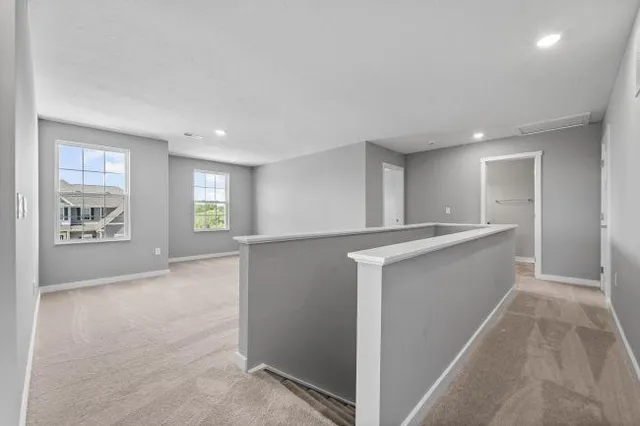 a view of an empty room with window and cabinet