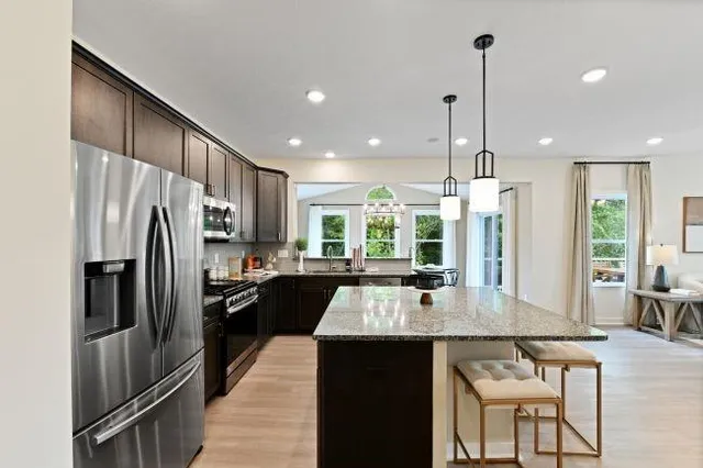 a large kitchen with kitchen island a large counter top space appliances and a center island