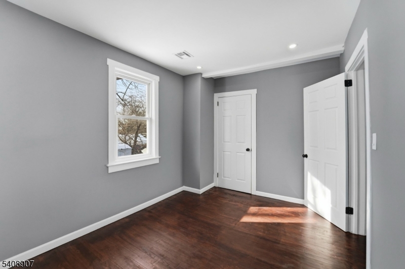 209 Vine Street Delanco, NJ 08075 - Photo 24 of 43 a view of an empty room with wooden floor and a window
