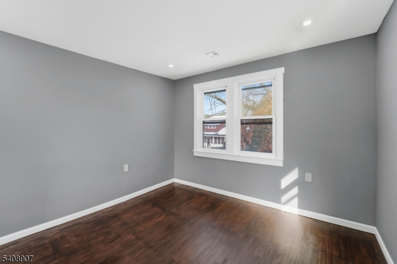 209 Vine Street Delanco, NJ 08075 - Photo 26 of 43 an empty room with wooden floor and windows