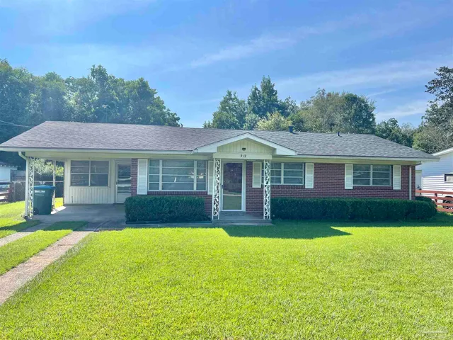 a front view of a house with a yard table and chairs