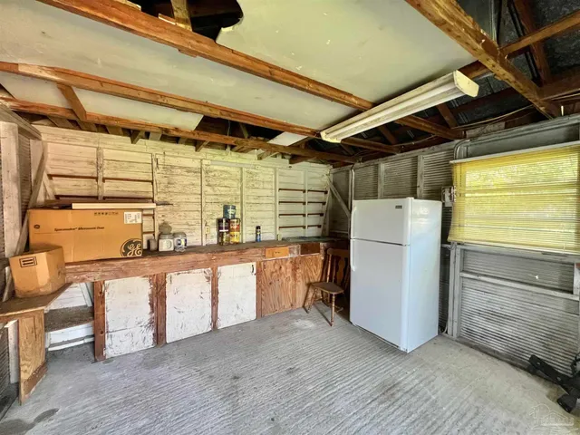 a kitchen with refrigerator and table