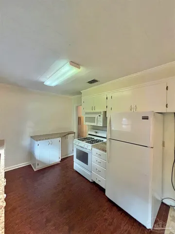 a kitchen with a refrigerator and a stove