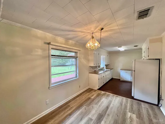 a large white kitchen with a large window