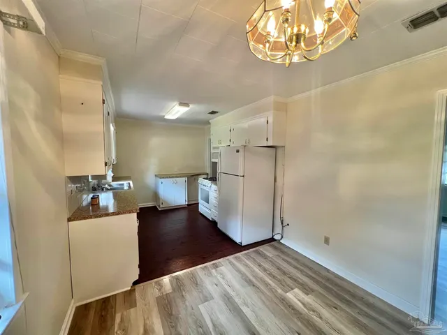 a view of a living room and chandelier