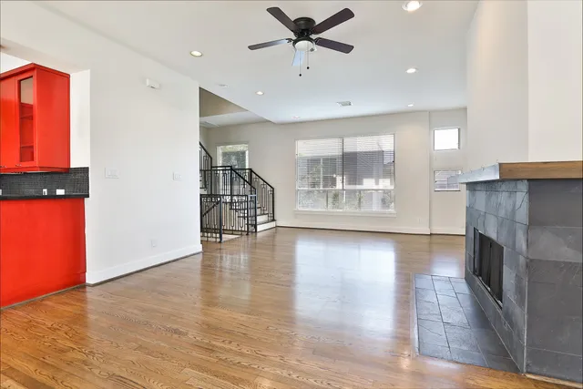 an empty room with wooden floor and a fireplace
