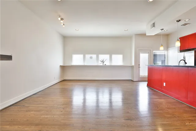 a view of kitchen and hall with wooden floor