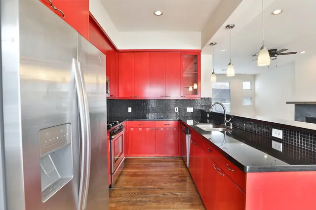 a kitchen with stainless steel appliances granite countertop a sink and a stove