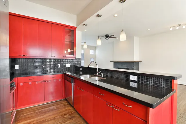 a kitchen with stainless steel appliances granite countertop a sink a stove and a microwave